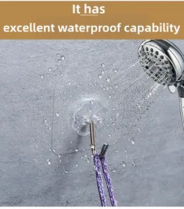 Waterproof transparent adhesive hook shown with water splashing to demonstrate durability