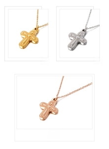 Detailed view of cross pendant necklaces in gold, silver, and rose gold finishes