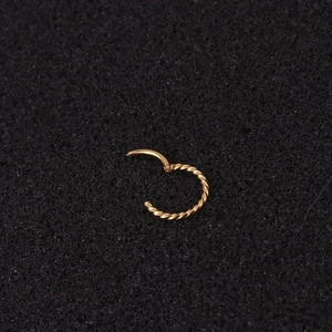 Golden twisted rope texture hoop earring with hinged closure and minimalist steel design