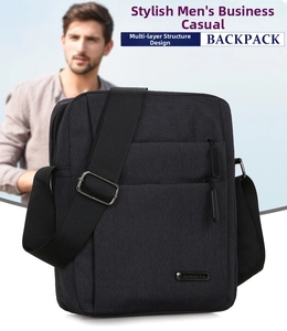 Detail view of the multi-layer zipper compartments and metal logo on the black oxford bag