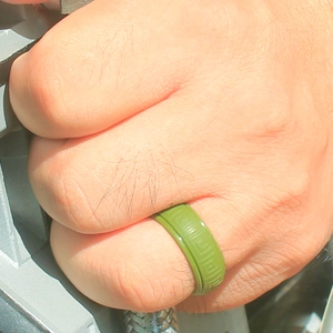 Detail of green silicone ring with Greek meander pattern worn during outdoor sports