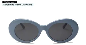 Detail view of dark blue oval frame sunglasses with grey lenses on a white background