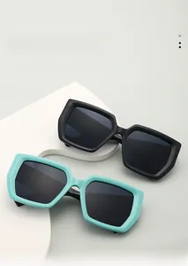 Close-up of matte black and tiffany blue thick frame square sunglasses with wide temples