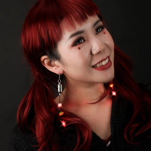 Luminous Christmas earrings with red LED light string on model with red hair