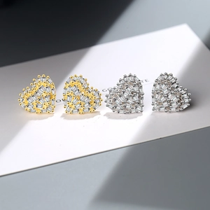 Elegant heart-shaped stud earrings featuring shimmering cubic zirconia in gold and silver