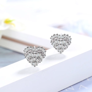 Sparkling silver heart stud earrings with cubic zirconia stones on white geometric stand