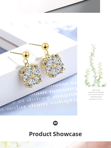 Macro detail of gold square zircon earrings with a geometric sunburst design