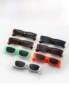 Detailed flat lay of rectangular sunglasses in various colors like orange and white