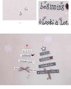 Detail of wooden Christmas star ornaments with bells and rustic plaid bows