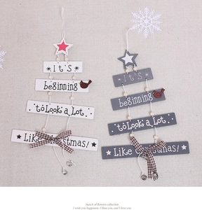 Detail of wooden Christmas tree hanging ornaments with star top and bell charms
