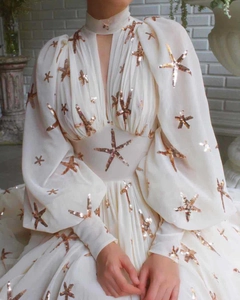 Detail of sequin starfish embroidery on cream high-neck lantern sleeve chiffon dress