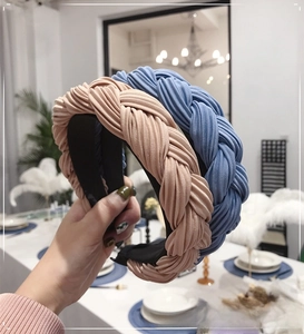 Detail of wide braided headband with plissé pleated fabric in soft pastel colors