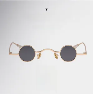 Macro detail of retro steampunk round sunglasses with gold frame and dark lenses