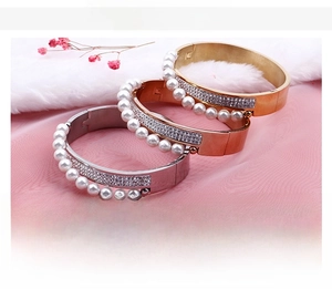 Three stackable stainless steel bracelets with zircon and shell pearls in gold, rose gold, silver