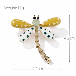 Fashionable dragonfly brooch with yellow wings, polka dots and green gemstone