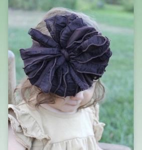 Detail of baby lace headband with large dark brown tulle floral decoration