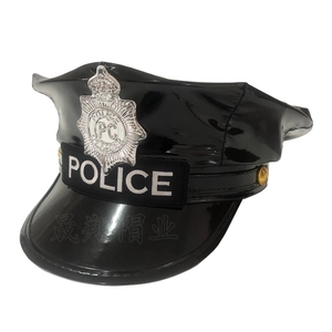 Detail of black patent leather police hat with silver badge and woven Police text