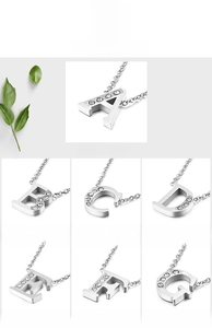 Detail showing various sparkling rhinestone-set capital letters on titanium necklaces