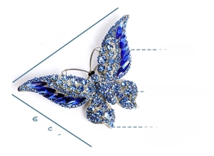 Detail of blue crystal butterfly brooch showing dimensions 9.5cm x 6.0cm and metal materials