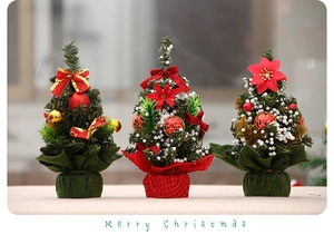 Close-up of three mini Christmas trees with red ornaments and Merry Christmas text