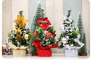 Detailed view of mini Christmas trees in gold, red, and silver with festive ornaments