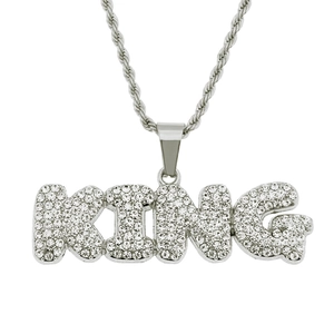 Macro shot of silver KING pendant set with sparkling rhinestones on a twist rope chain