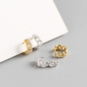 Macro view of gold and silver S925 sterling silver chain earrings with pavé stones