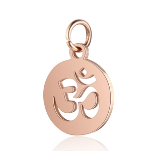 Macro shot of rose gold stainless steel round pendant with hollow Om symbol detail