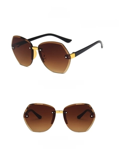 Detail view of stylish gradient tea rimless polygon sunglasses for kids with gold metal bridge