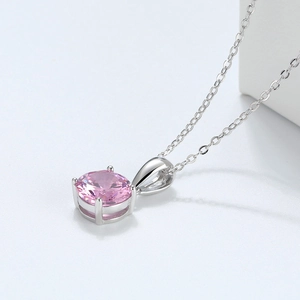 Macro shot of S925 sterling silver necklace with a round pink zircon in a claw setting