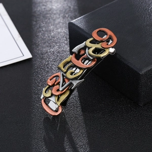Steampunk style alloy hair clips in bronze and silver finishes on a textured background