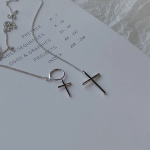 Detailed view of S925 sterling silver cross double pendants on a minimalist chain