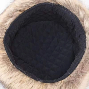 Close-up of winter hat interior featuring black quilted lining and soft faux fur trim