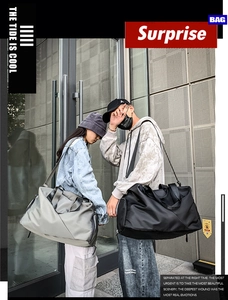 Outdoor street style shot of large capacity travel duffel bags in black and gray color