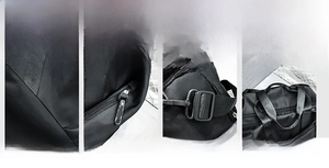Detail of durable fabric, reinforced handles and metal zippers on a black travel bag