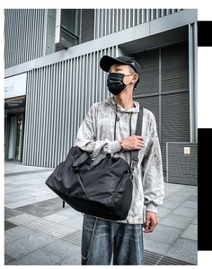 Detailed look at the large black waterproof travel bag with shoulder strap and side pockets
