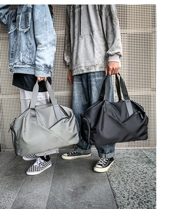 Outdoor fitness gym bags in grey and black colors displayed by models in street style