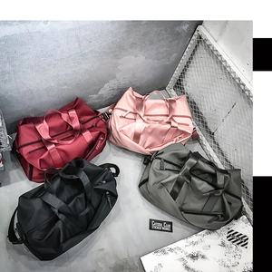 Group display of waterproof nylon duffle bags in burgundy, pink, black, and army green colors