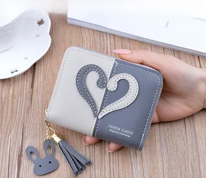 Detail of color-block mini wallet with heart stitching and cute rabbit leather charm