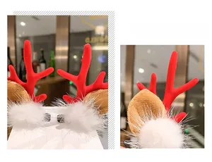 Detailed close-up of handmade Christmas hair clips with red antlers and white fur balls