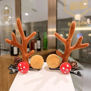Christmas reindeer antler hair clips with pine cones and mushrooms on display card