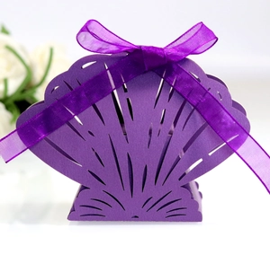 Elegant laser cut purple shell-shaped wedding candy box with a matching silk ribbon bow