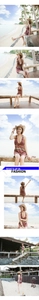 Detail of hollow-out straw sun hat with bohemian striped dress and sunglasses for beach