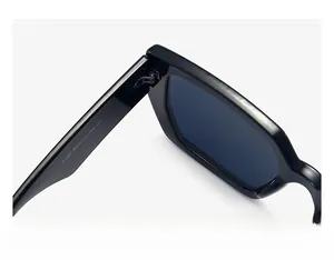Detailed macro view of the durable metal hinge and frame specs on black retro sunglasses