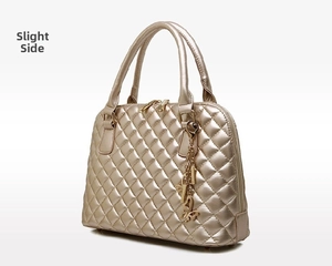 Side view of champagne quilted leather handbag with gold butterfly charm detail