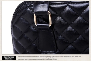 Detail showing reinforced handle attachment and quilted stitching on black leather bag
