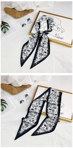 Detail of long silk scarf with black and white jungle animal print for bags and hair