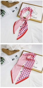 Detailed view of polka dot silk scarf tied on a woven bag with a pink and blue pattern