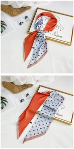 Detail showing orange and light blue silk scarf with horse print tied on a frame