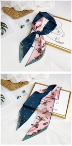 Detail of floral silk scarf showing elegant navy and pink reversible floral patterns